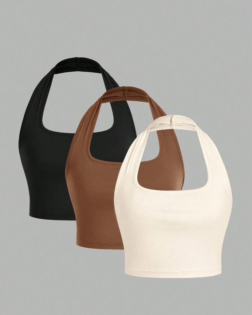 Three halter neck cropped camisole tops in different colors displayed together