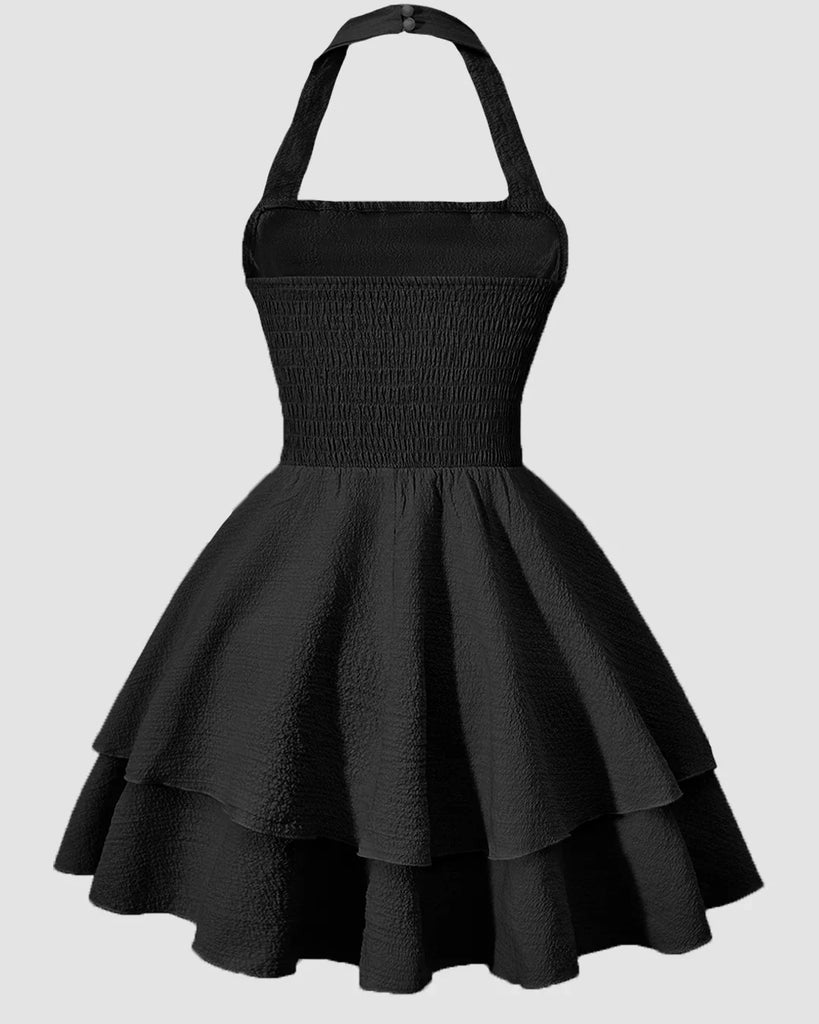 Back view of a Black halter neck mini dress with a ruched waist and a tiered ruffled skirt, perfect for a stylish evening out.