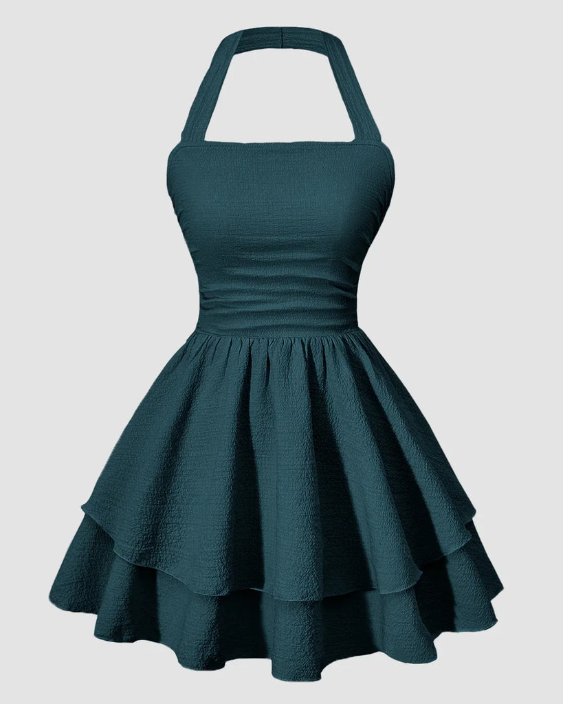 Teal green halter neck mini dress with a ruched waist and a tiered ruffled skirt.
