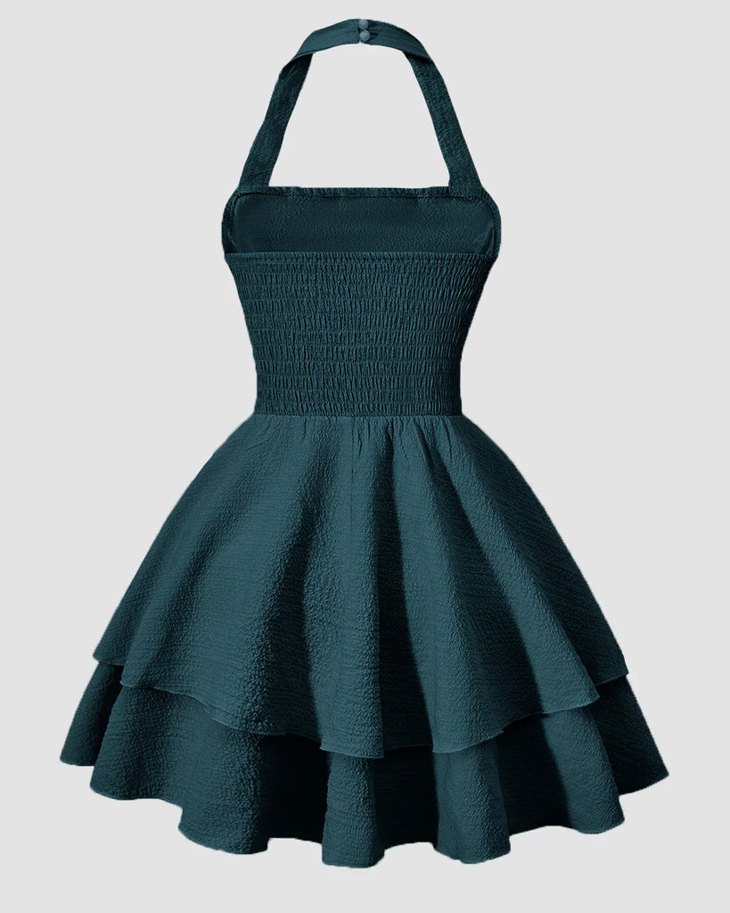 Back view of a Teal green halter neck mini dress with a ruched waist and a tiered ruffled skirt.