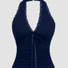 Front view of Navy blue halter neck sleeveless top with contrast lace trim, slim fit and backless design