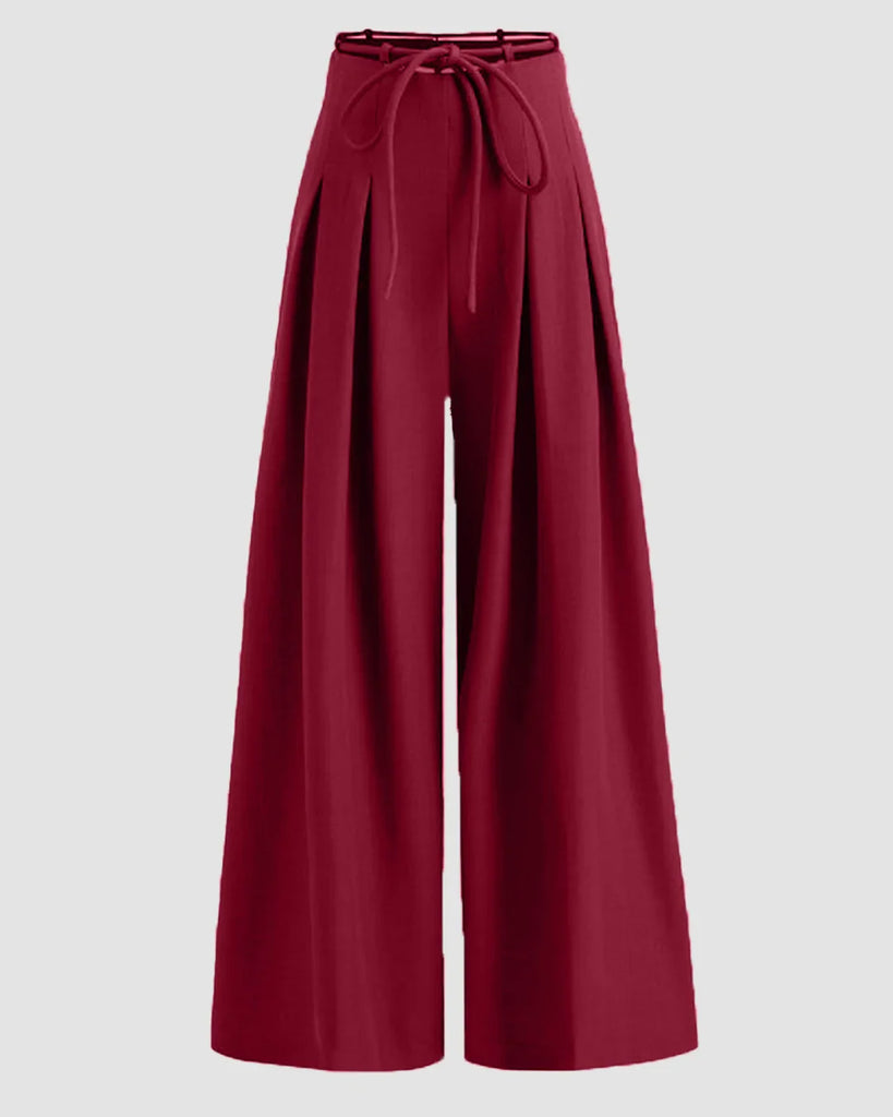 High-waist burgundy wide-leg trousers with pleats and tie-belt detail, designed for a stylish and comfortable fit.