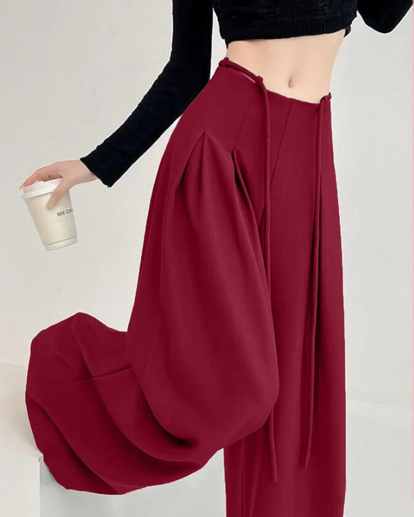 High-waist burgundy wide-leg trousers with pleats and tie-belt detail, designed for a stylish and comfortable fit.