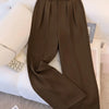 Front view of womens tailored trousers in brown with high waist, pleated front and straight leg silhouette.