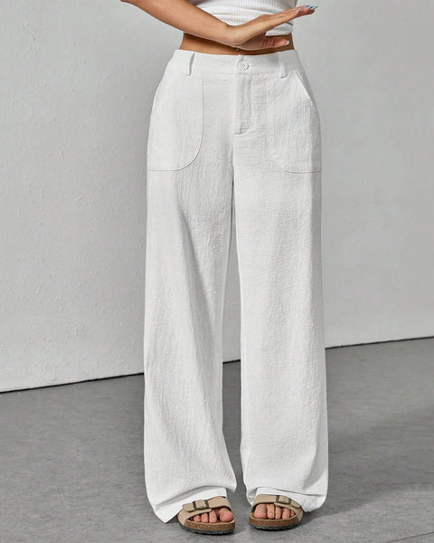 Front View of White linen wide leg pants featuring a high waist fit, relaxed straight silhouette and soft textured fabric styled with sandals