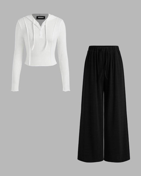 Top and trouser set featuring white hooded top paired with black mid-rise wide-leg trousers, showcasing a stylish and comfortable outfit set.