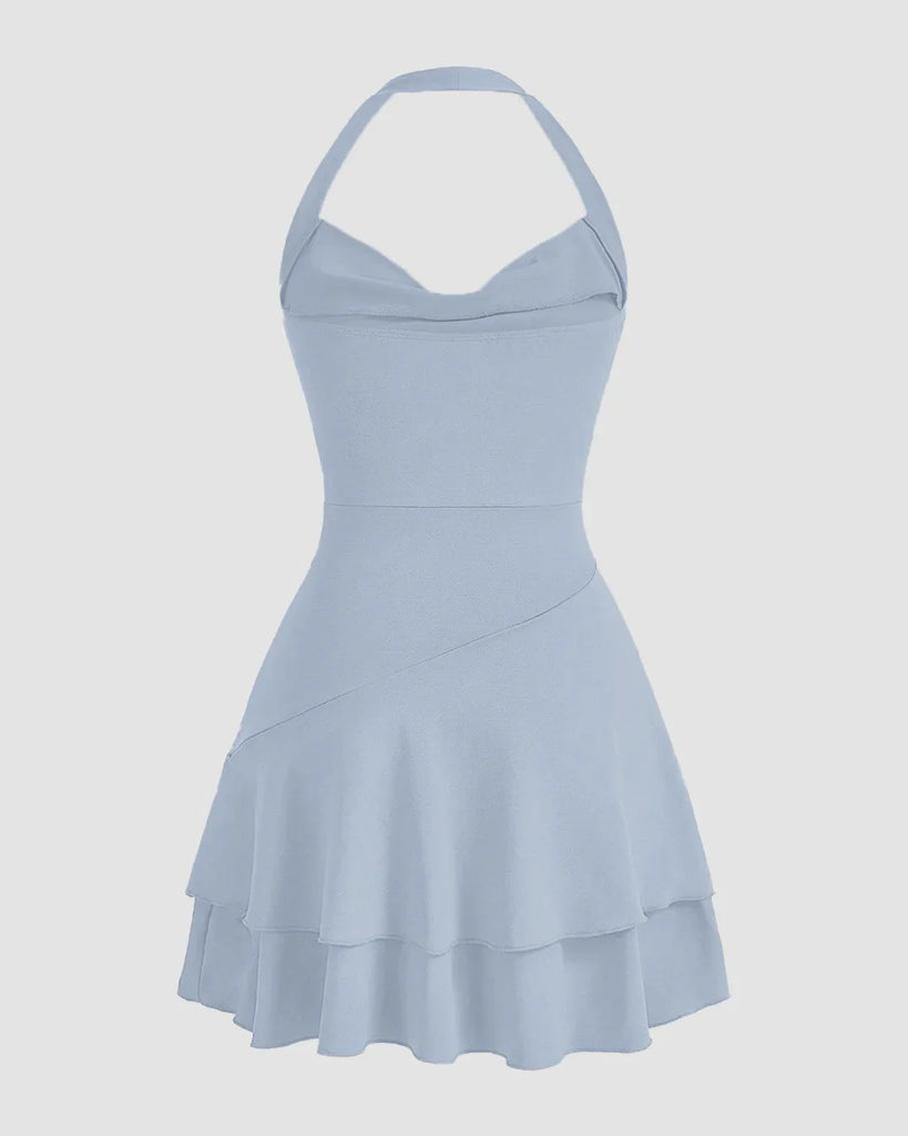 Back view of a Light blue halter neck dress with a ruched bodice and a ruffled skater skirt, perfect for a summer outing.
