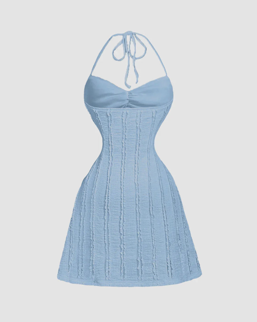 Back view of a Dusty blue knitted halter neck mini dress with back tie, front tie detail, and open back for a flattering fit.
