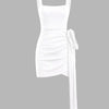 White square-neck sleeveless mini dress with ruched detailing, asymmetrical hem, and a knotted tie accent