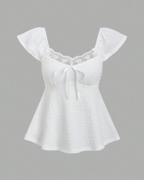 Front view of front bow tie top in white with ruffle sleeves, square neckline and flared peplum hem, cute summer style
