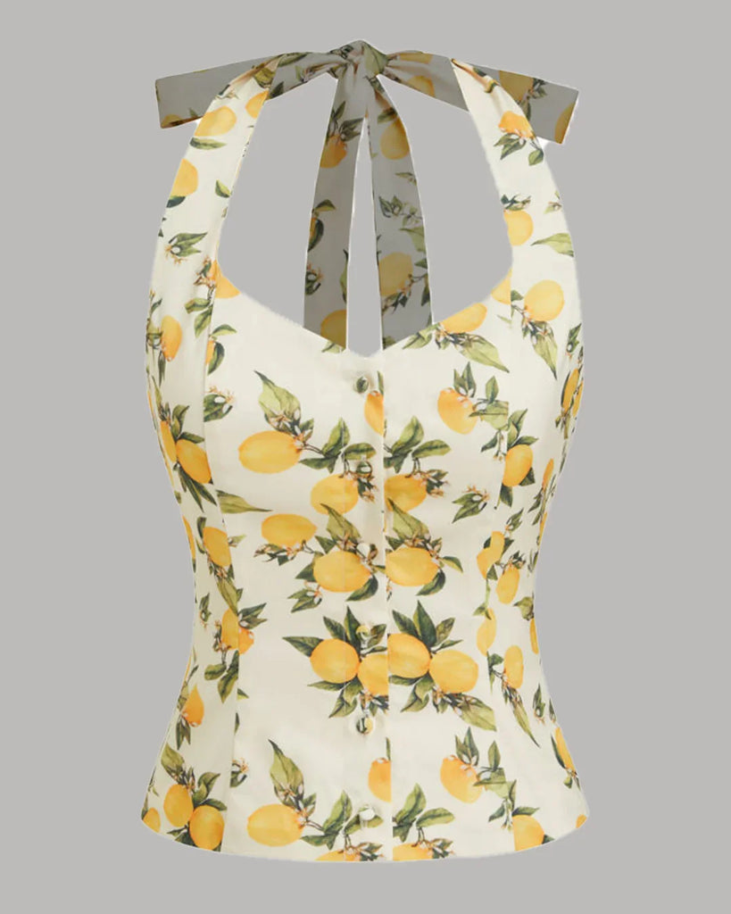 White and yellow lemon print halter neck top with a ruched design and a stylish bow detail.
