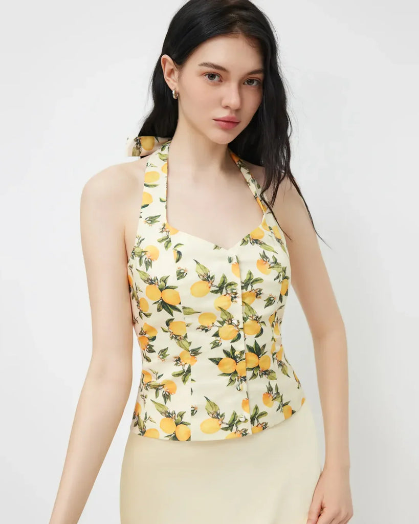 White and yellow lemon print halter neck top with a ruched design and a stylish bow detail.