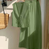 A green sleeveless tie-back top and wide-leg pants co-ord set displayed on a wall.
