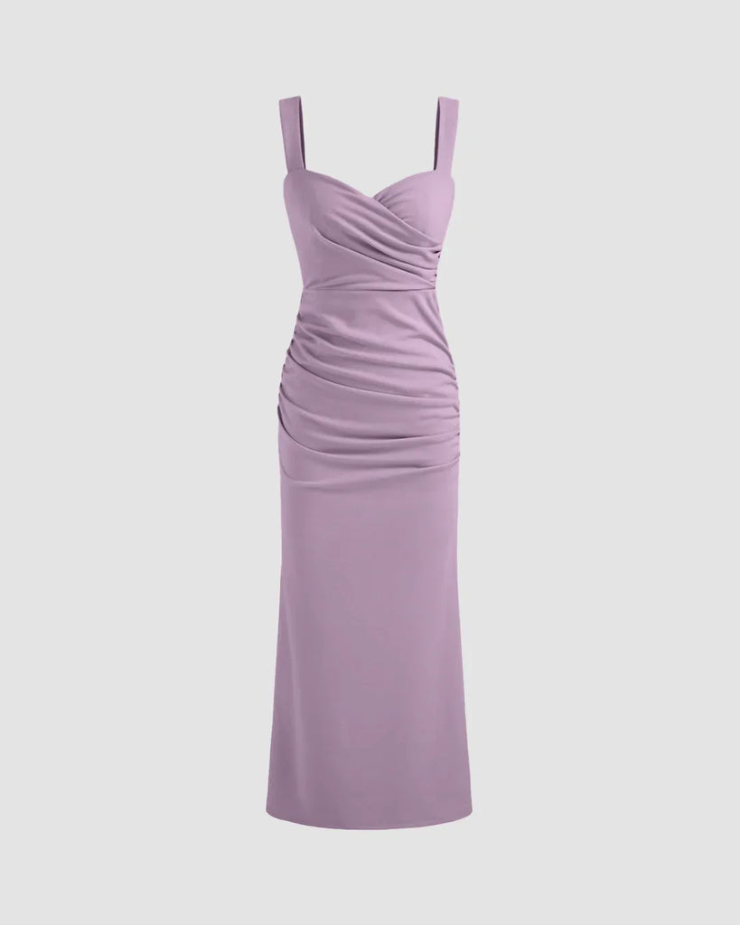 Lilac V-neck midi dress featuring a ruched bodice, fitted waist, and subtle fishtail hem for a flattering silhouette.
