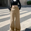 A woman models light brown wide-leg cargo pants and a matching crop top, showcasing a relaxed and stylish outfit