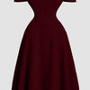 Front view of Maroon one shoulder romantic dress with faux fishbone design and flared skirt, featuring a structured elegant silhouette