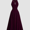 Front view of Flared maxi dress with halter neckline and flowy skirt, featuring a fitted bodice and elegant drape in a studio product view