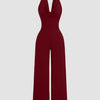 Maroon halter cowl neck jumpsuit with wide legs, made from stretchy fabric for a comfortable fit.