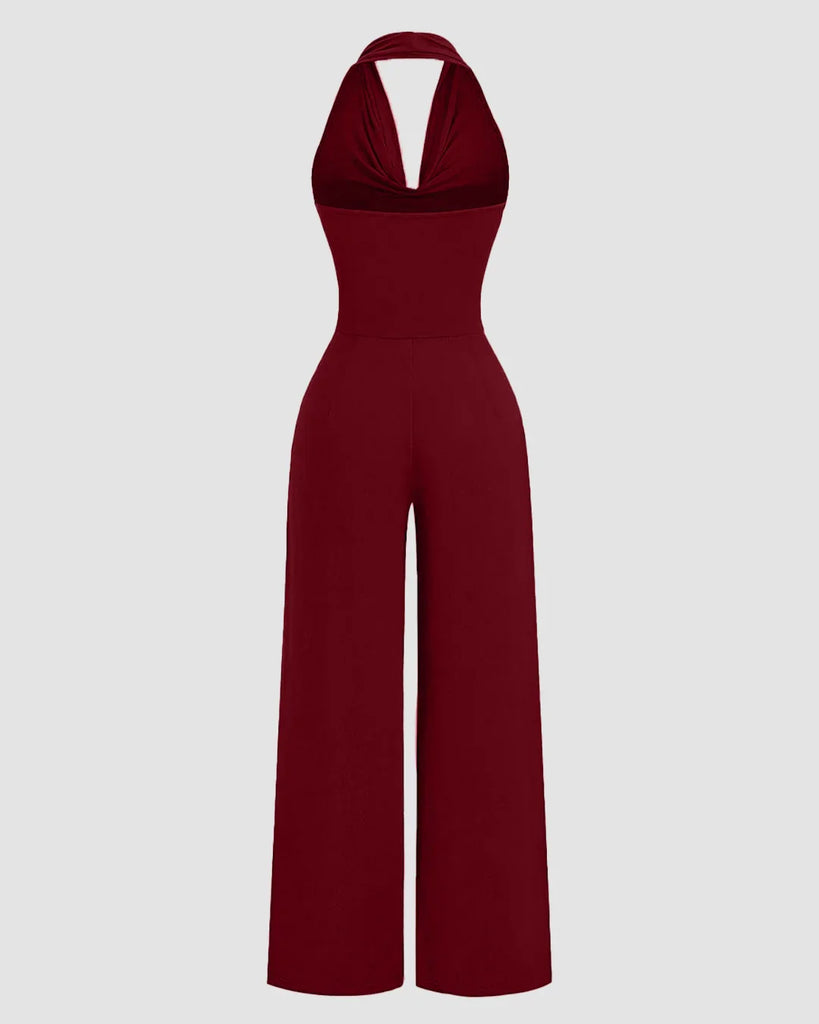 Back view of a Maroon halter cowl neck jumpsuit with wide legs, made from stretchy fabric for a comfortable fit.