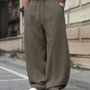 Front view of Grey oversized sweat track pants for men with drawstring waist, wide legs, and relaxed streetwear fit style.