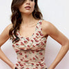 Women wearing printed crop top with floral print and cowl neckline, featuring ruched detailing and a flared hem for a soft feminine silhouette