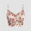Front view of Floral mesh crop top with a V-neckline, ruched front, and thin strappy shoulders, offering a fitted and feminine summer look.