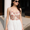 Women wearing Floral mesh crop top with a V-neckline, ruched front, and thin strappy shoulders, offering a fitted and feminine summer look.