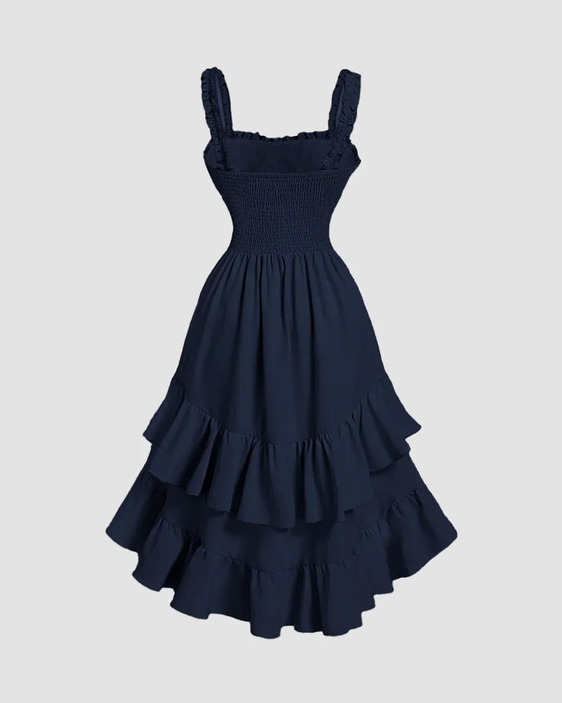 Back view of a Navy blue midi dress with a square neck, ruched bodice, and ruffled high-low hemline.