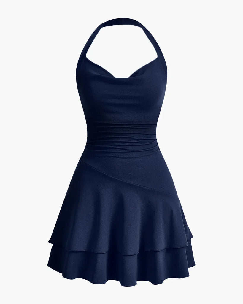Navy halter neck skater dress with ruched waist and double-layered flared hem, offering a fun and flattering fit.