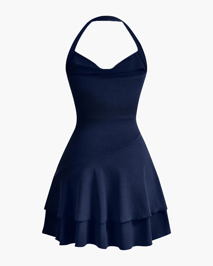 Back view of a Navy halter neck skater dress with ruched waist and double-layered flared hem, offering a fun and flattering fit.