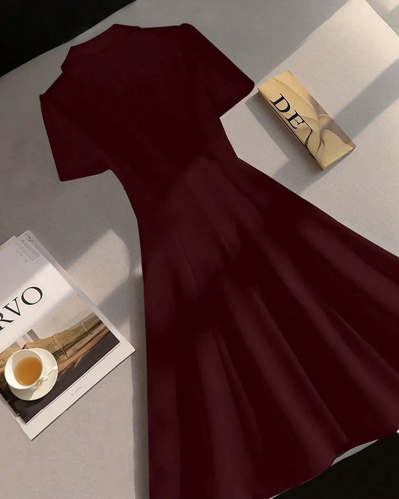 Burgundy fit and flare mini dress with buttons and a book, featuring a notch collar design.