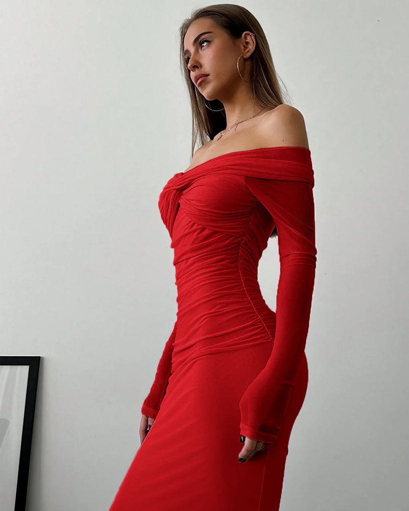 A woman in a dark red off-shoulder mesh ruched fitted dress with long sleeves.