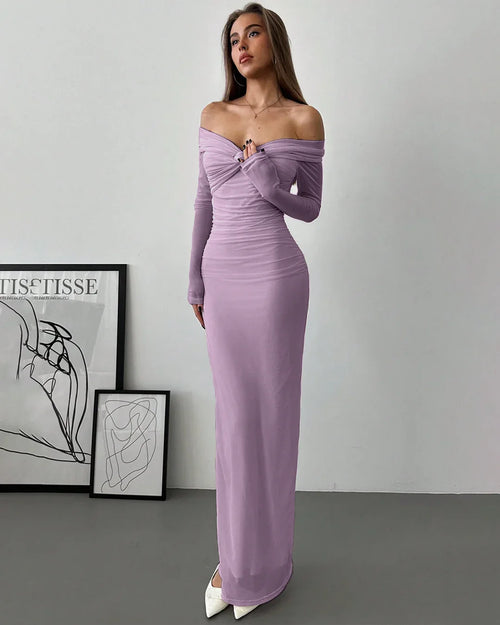 Model wearing a lilac off-shoulder mesh ruched fitted dress with long sleeves, showcasing a stylish and elegant look.
