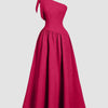 One-shoulder hot pink midi dress featuring a bow detail on the back and a fit-and-flare silhouette.
