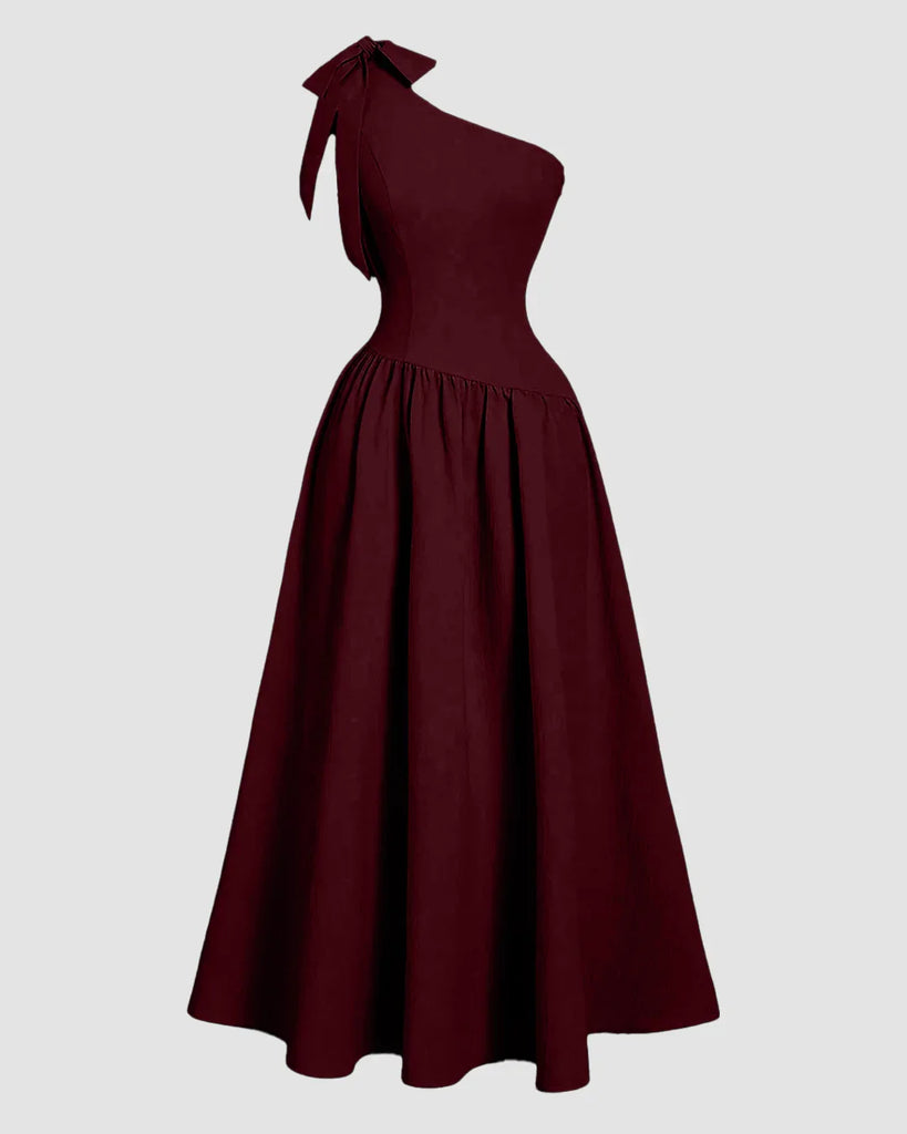 Burgundy one-shoulder midi dress featuring a bow at the neck and a fit-and-flare silhouette.