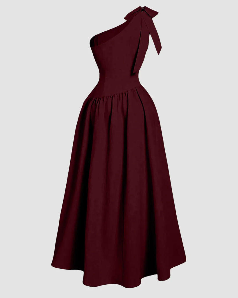 Burgundy one-shoulder midi dress featuring a bow at the neck and a fit-and-flare silhouette.