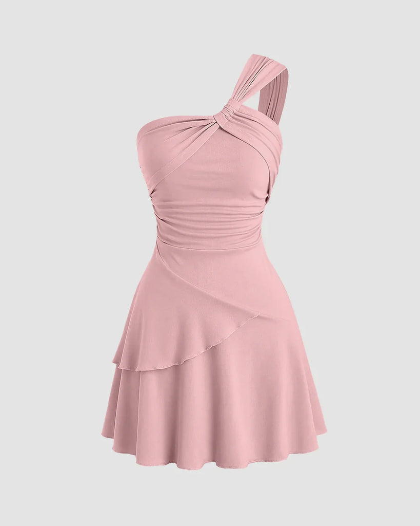Dusty pink one-shoulder mini dress with ruched bodice and layered hem, perfect for a night out or special occasions.