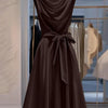 Front view of Coffee brown dress with draped cowl neckline, sleeveless design and waist tie detail creating a graceful flared silhouette