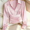 Front view of Pink satin shirt with collared neckline, long sleeves and ruched waist detail, featuring a soft sheen and tailored fit