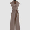 Brown jumpsuit with a plain collar, pockets, and a belt, showcasing a simple yet stylish design