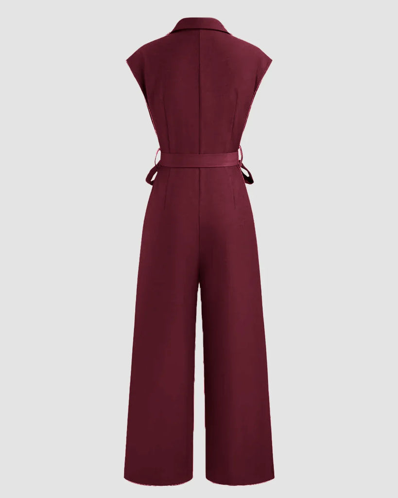 Back view of a Burgundy cotton jumpsuit featuring a plain collar, pockets, and a belt, designed for comfort and style.
