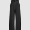 Front view of Black pleated wide leg trousers with high waist, belt loops, smooth fabric, and full length tailored silhouette.