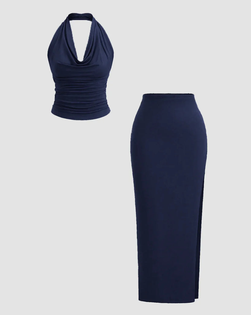 Two-piece navy blue dress featuring a plunge neck backless halter top and a slit side skirt.