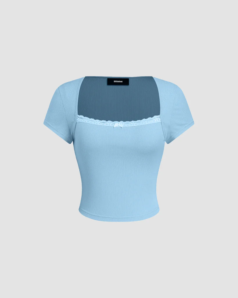 Powder blue fitted top featuring a sheer lace neckline detail, showcasing a stylish and elegant design