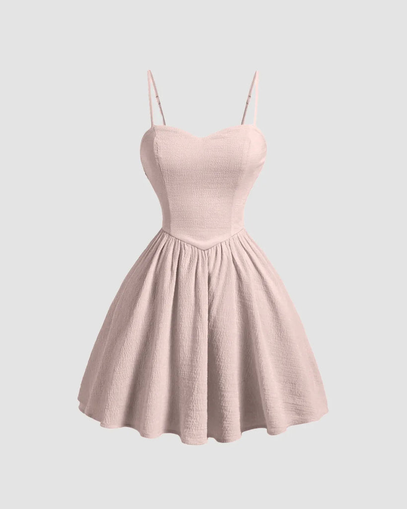 Powder pink sleeveless mini dress featuring a flared silhouette for a soft, playful elegance.