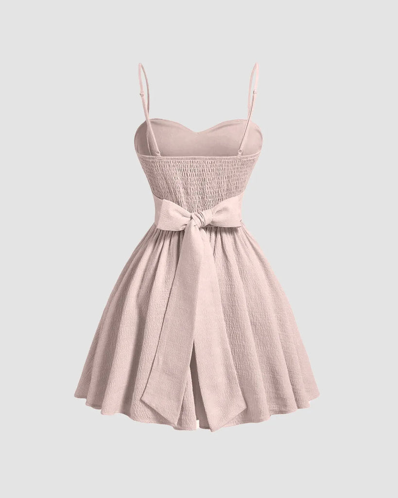Powder pink sleeveless mini dress featuring a flared silhouette for a soft, playful elegance.