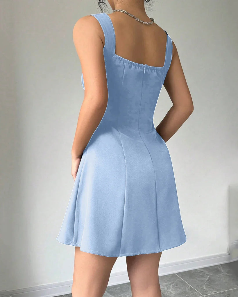 Back view of a light blue Rainwash fit and flare mini dress takes a selfie, smiling at the camera.