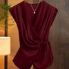 Front view of red v neck top with draped wrap style, cap sleeves and tie waist detail for a flattering fit.
