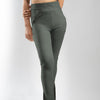 A woman models regular fit high rise trousers in olive green, showcasing a stylish and comfortable outfit choice.