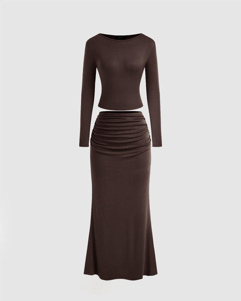 Front view of A chocolate brown top and skirt set featuring long sleeves and a ruched mini skirt.
